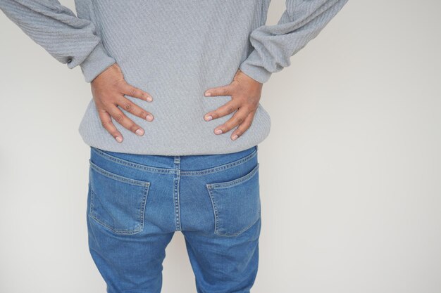 Photo young man suffering back pain close up