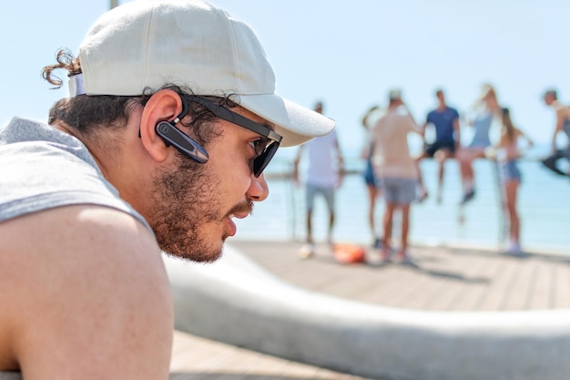 Young man in sunglasses at the beach