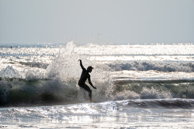 Young man surfing the waves on the pacific ocean