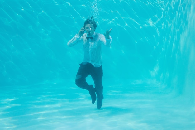 Young man swimming underwater