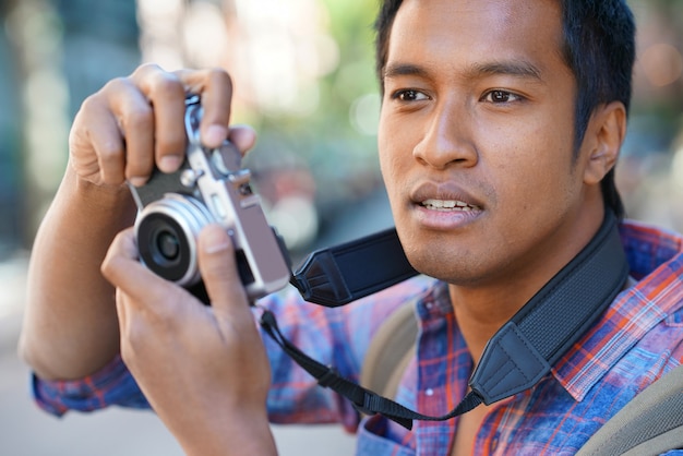 Young man taking picture in NYC neighborhood