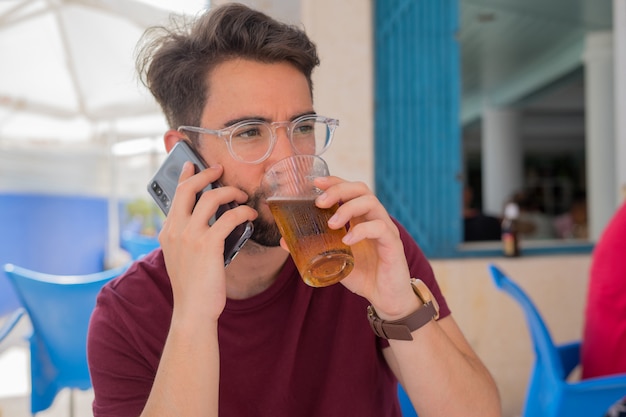 Young man talking for mobile phone in the restaurant