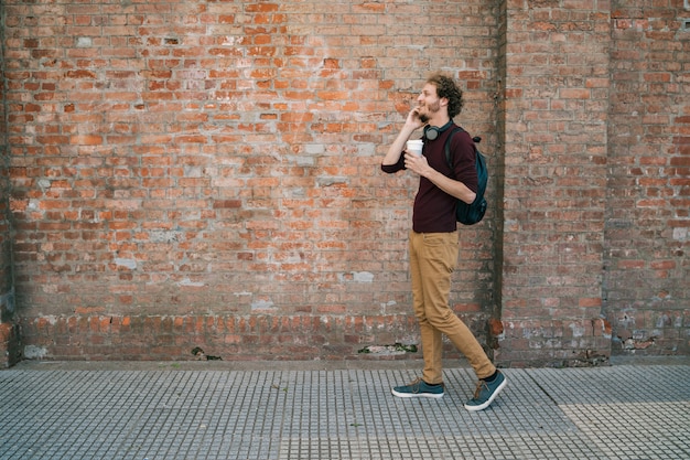 Young man talking on the phone outdoors