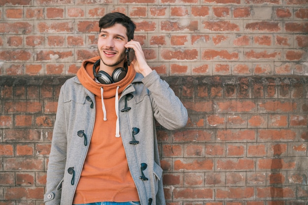 Young man talking on the phone outdoors