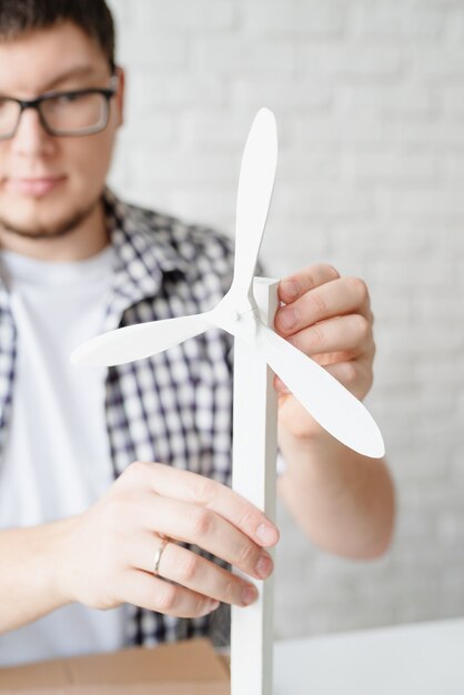 Young man teaching online making renewable energy dummy