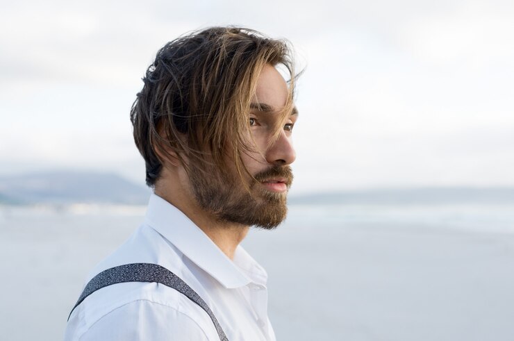 Young man thinking at the beach