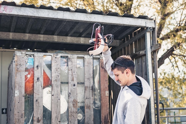 A young man throws electrical appliances into a container