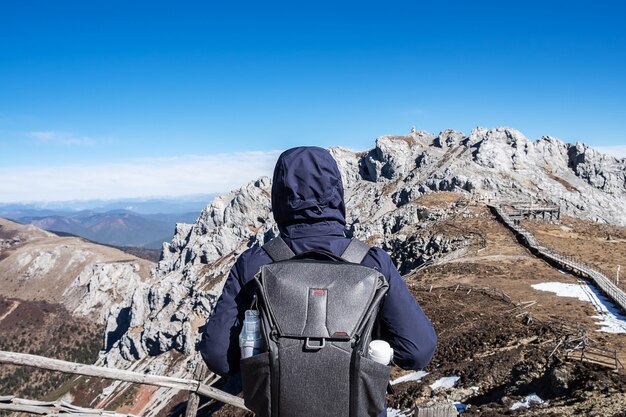 Young man traveler traveling at Shika Snow Mountain or Blue Moon Valley