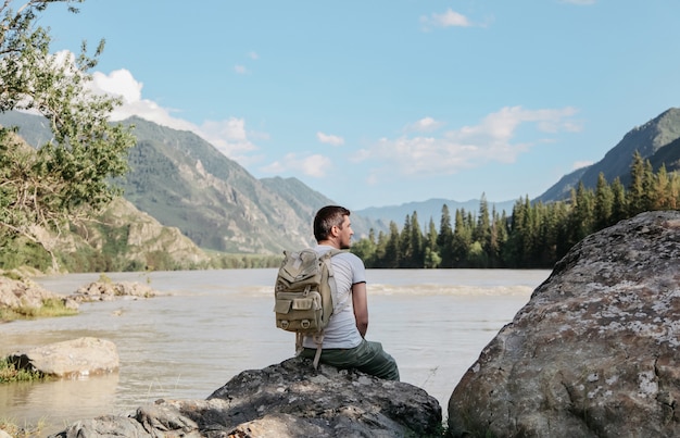 The young man travels around mountains