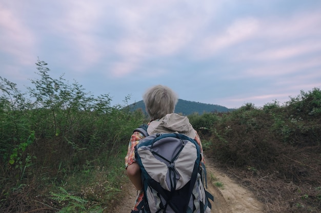 Young man trekker enjoy traveling with backpack, hiking concept, travel concept