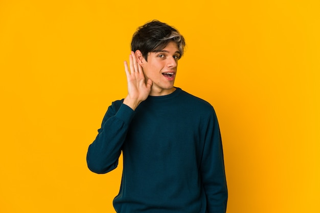 Young man trying to listening a gossip