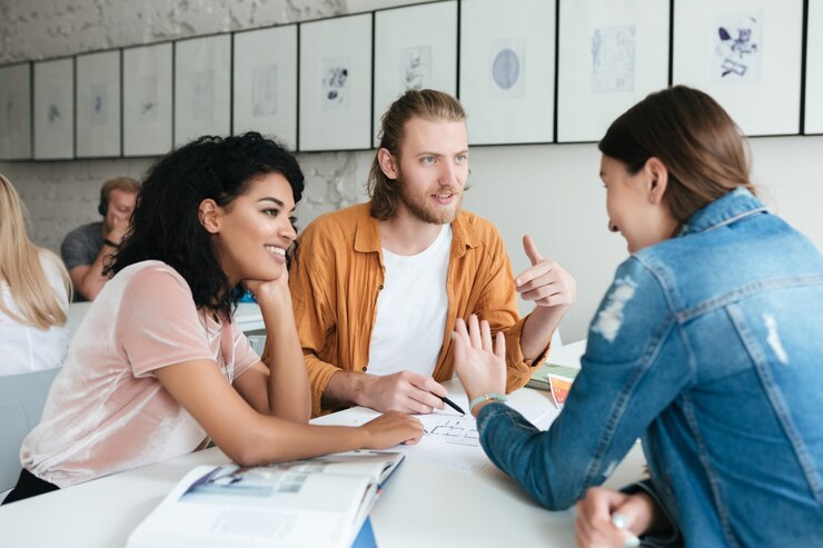 Young man and two womans working together in the office
