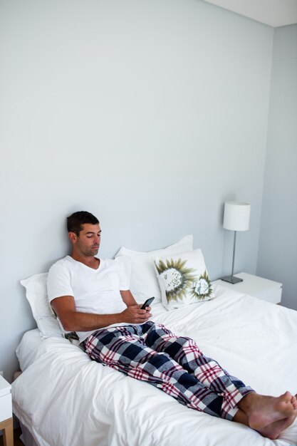 Young man typing a text message on phone