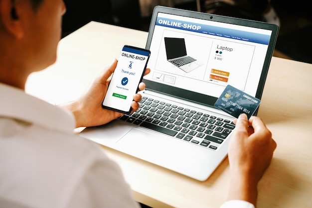 young man use credit card for online shopping uds