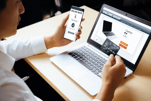 young man use credit card for online shopping uds