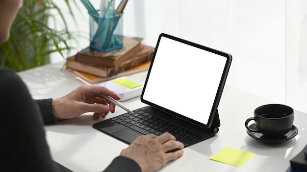 Young man using computer tablet internet surfing at home office room.