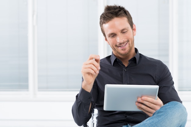 Young Man Using Digital Tablet