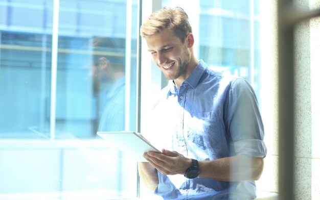 Young man using his tablet in the office