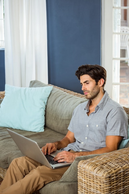 Young man using laptop in living room