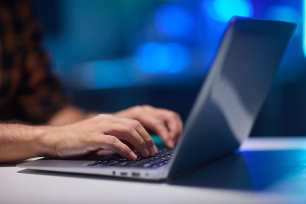 Young man using laptop in room at home