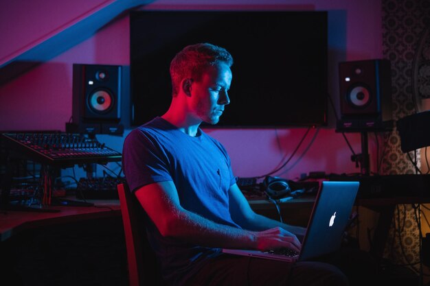 young man using laptop while sitting at home