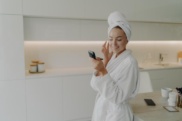 Photo young man using mobile phone in bathroom