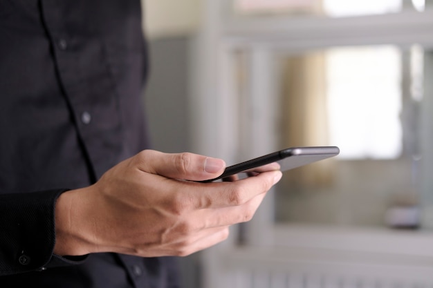 Young man using mobile phone. Using online connect technology for business, education and communication.