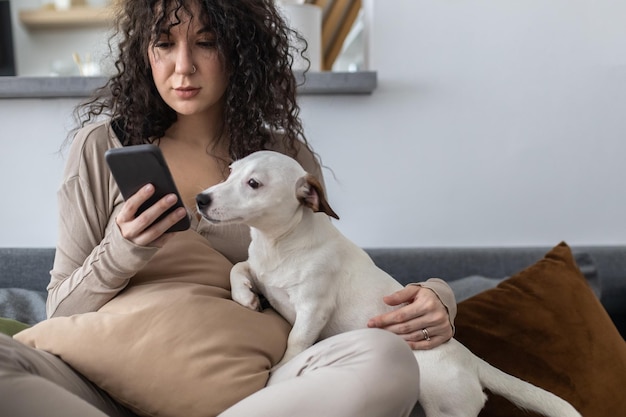 Young man using mobile phone while sitting on sofa