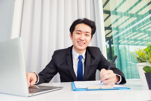 Young man using mobile phone while sitting on table