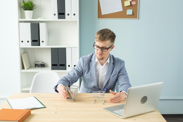 Young man using mobile phone while sitting on table