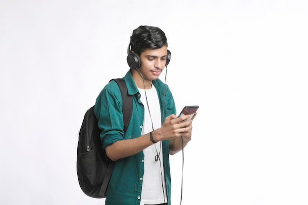 스마트폰과 헤드폰 액세서리를 사용하는 젊은 남자.