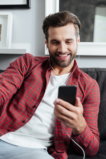 Young man using smartphone to make a videocall