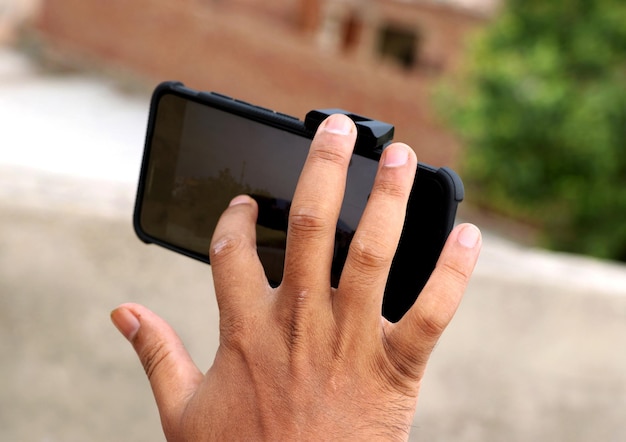 Young Man using smartphone to taking some photo Selective focus