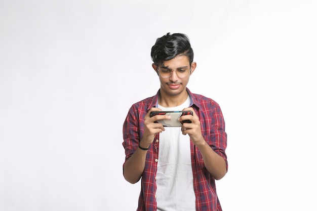 Young man using smartphone on white background.