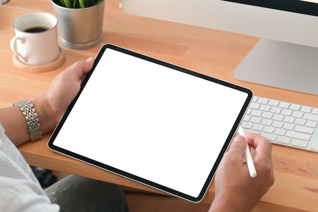 Young man using a tablet in office workspace