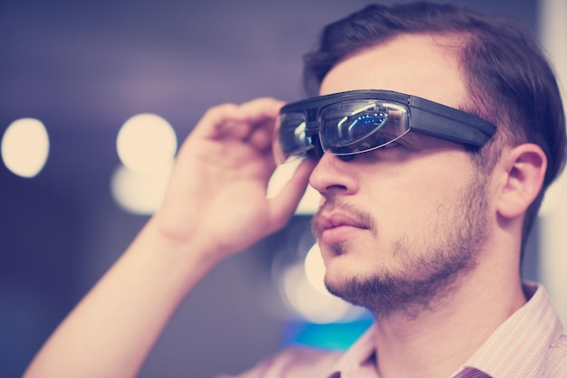 young man using virtual reality gadget computer technology glasses