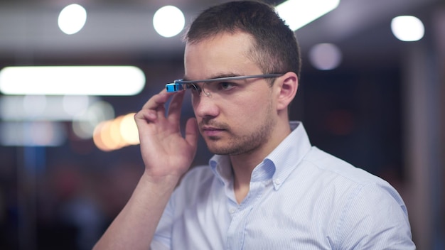 young man using virtual reality gadget computer technology glasses