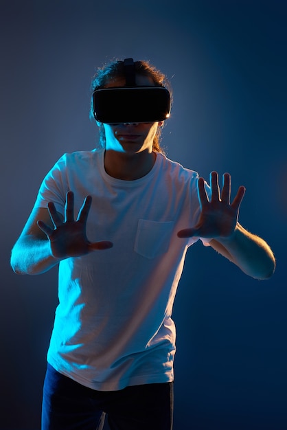 Young man using virtual reality headset. VR gadgets