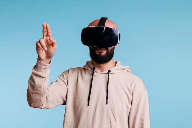 Young man in vr helmet making gesture