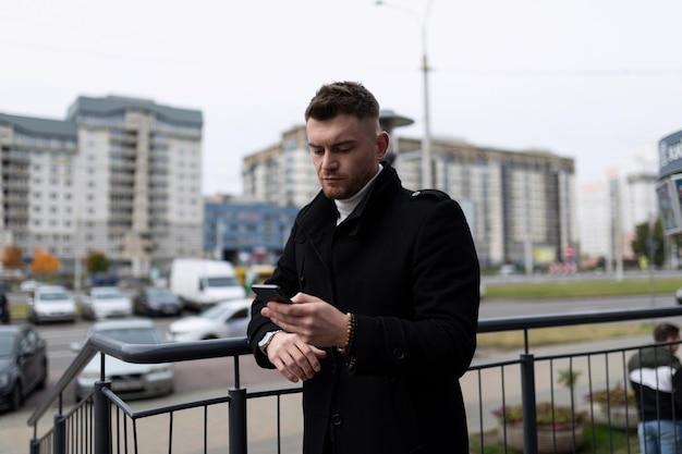 Young man waiting for a meeting looking at his watch in the office