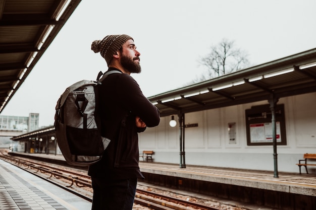 A young man waiting at the train station