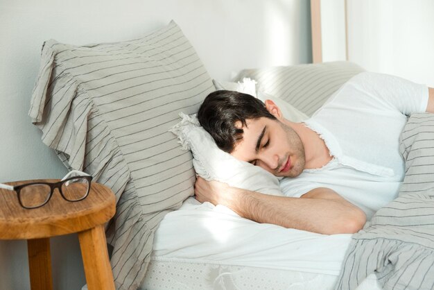 A young man wakes up from the first ray of the sun