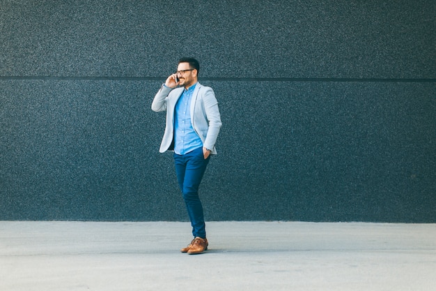 Young man walking and talking over the mobile phone  outdoor