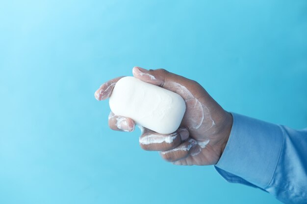 Young man washing hands with soap warm water