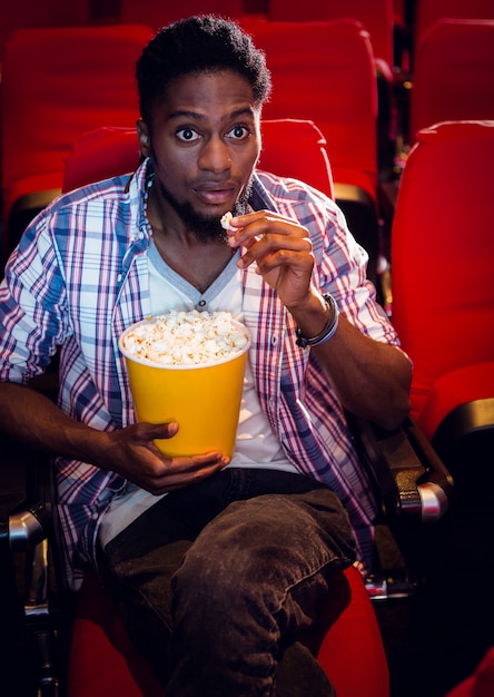 Young man watching a film