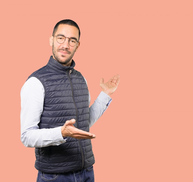 Young man waving with his hand