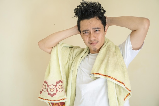 young man wear white clothes with towel laziness gesture