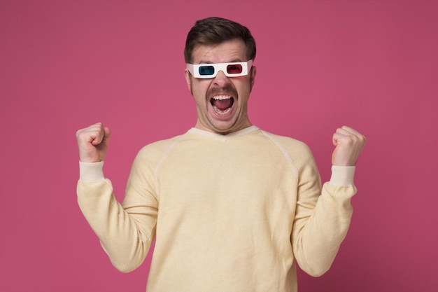 Young man wearing 3d glasses enjoying the film