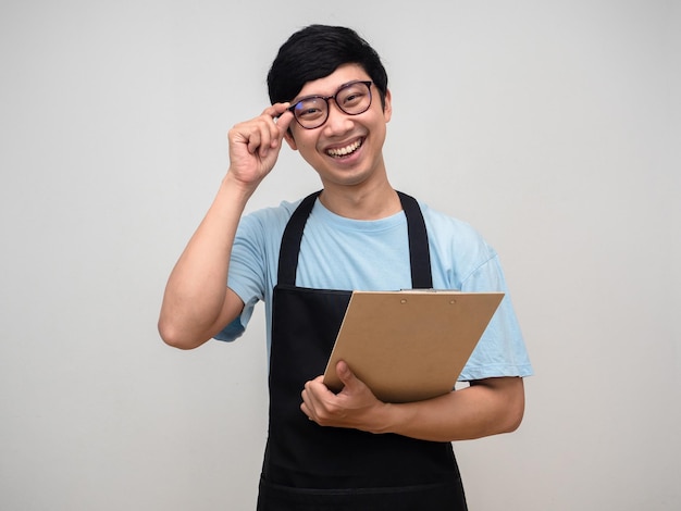 Young man wearing apron happiness smile holding check list board isolated