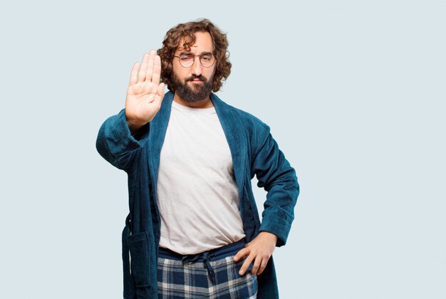 Young man wearing bathrobe night suit scared sign